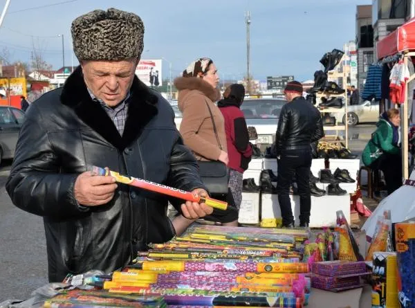 Мужчина выбирает петарды на ярмарке в Грозном